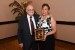 Dr. Nagib Callaos giving Dra. María Dolores García Perea a plaque "Por su Excelente Ponencia Plenaria."